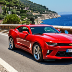 **Image Prompt:** A vibrant photo showcasing a red Camaro SS speeding along the Corniche road in the French Riviera, with the Mediterranean Sea sparkling in the background. The focus is on the car's aggressive design and the scenic coastal drive. Capture the feeling of freedom and exhilaration.